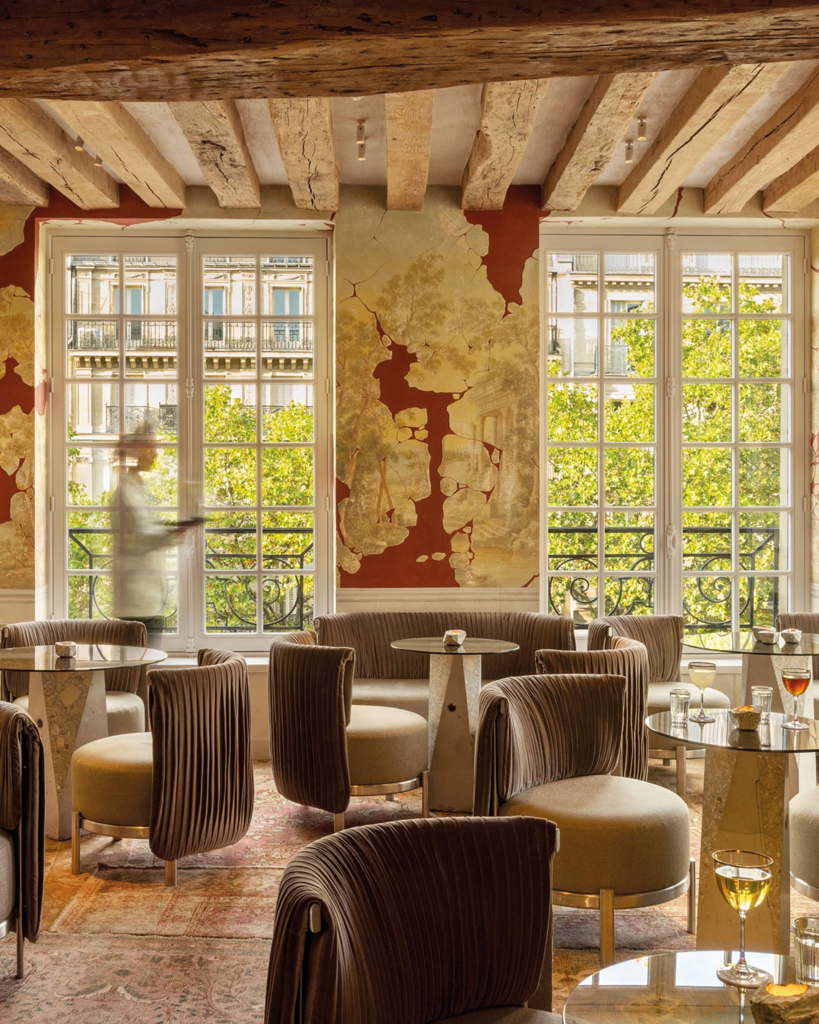 Cravan bar interior in Paris, with exposed ceiling beams and intimate bar tables.