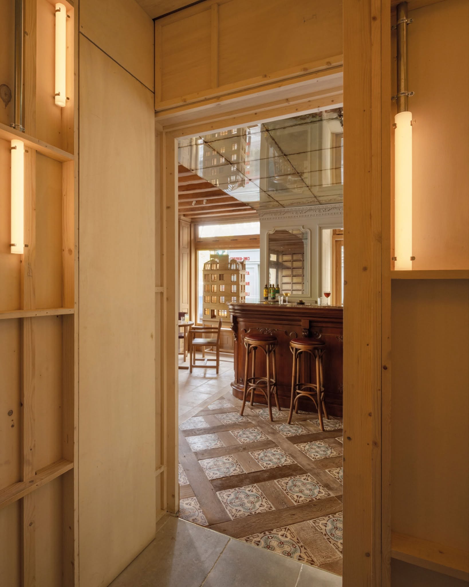 Cravan bar interior with industrial wood panelling and tiled floors.