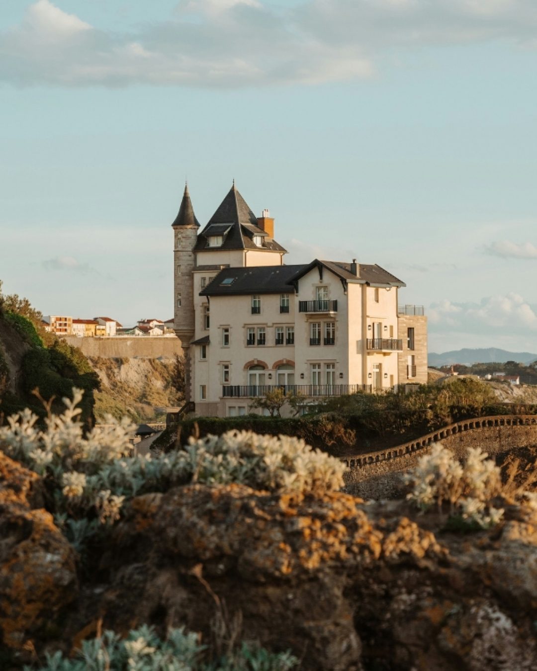Biarritz, on the southwest coast of France, with historic buildings along the rocky landscape.
