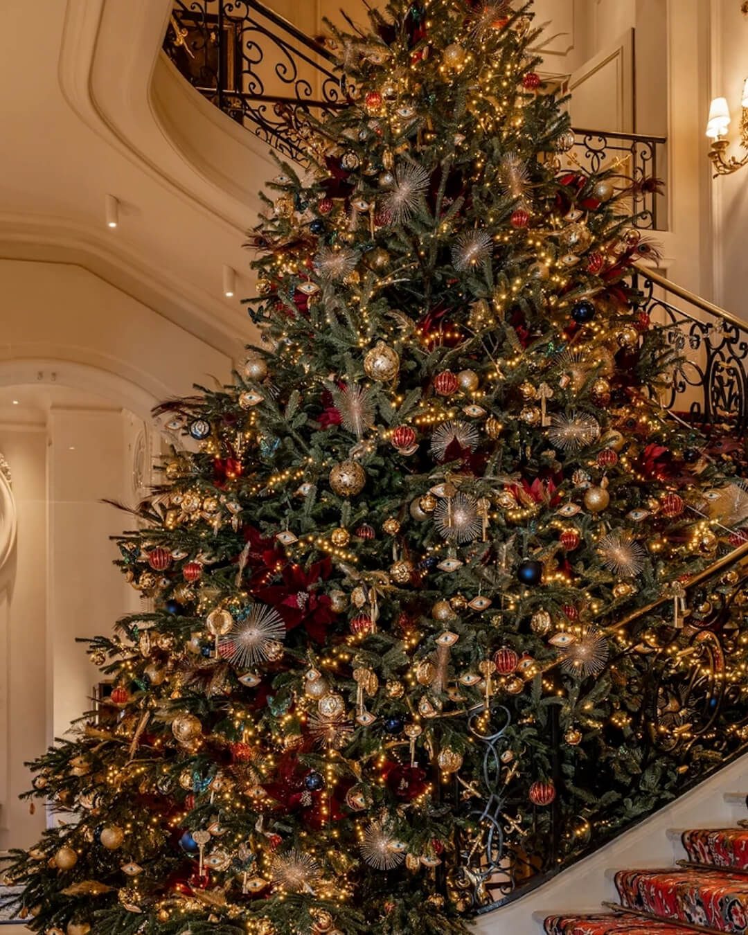Christmas Tree in the Ritz Hotel, Paris decorated with colorful ornaments, bows, and holiday lights.