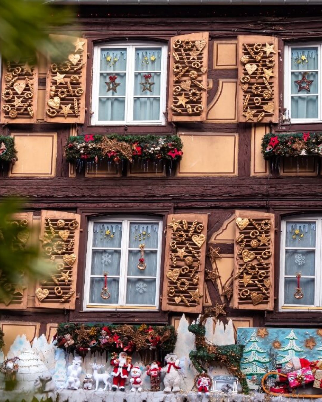 French holiday decorations on building facade in Colmar, France.