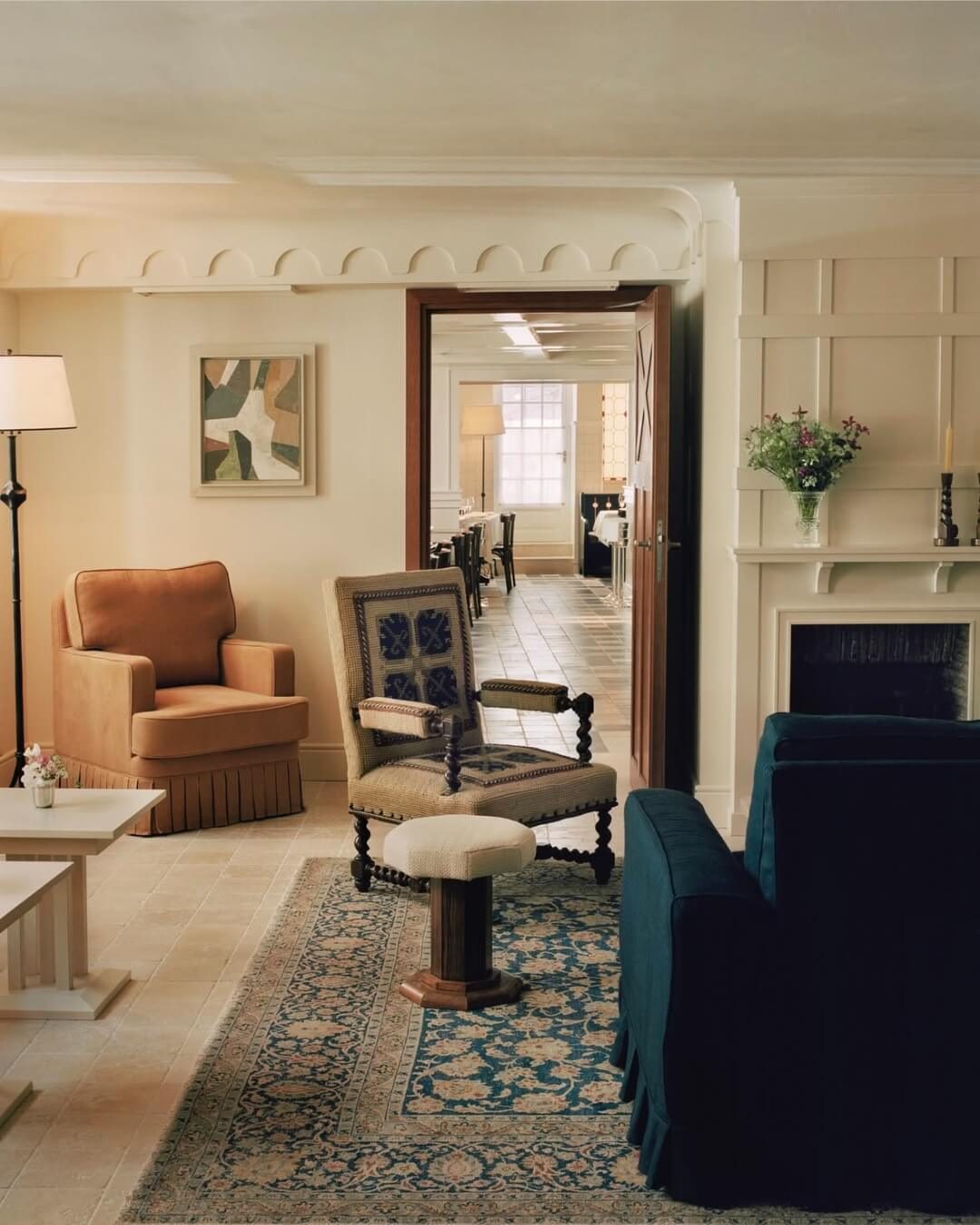 Chateau Voltaire salon interior with plush chairs and antique furniture.