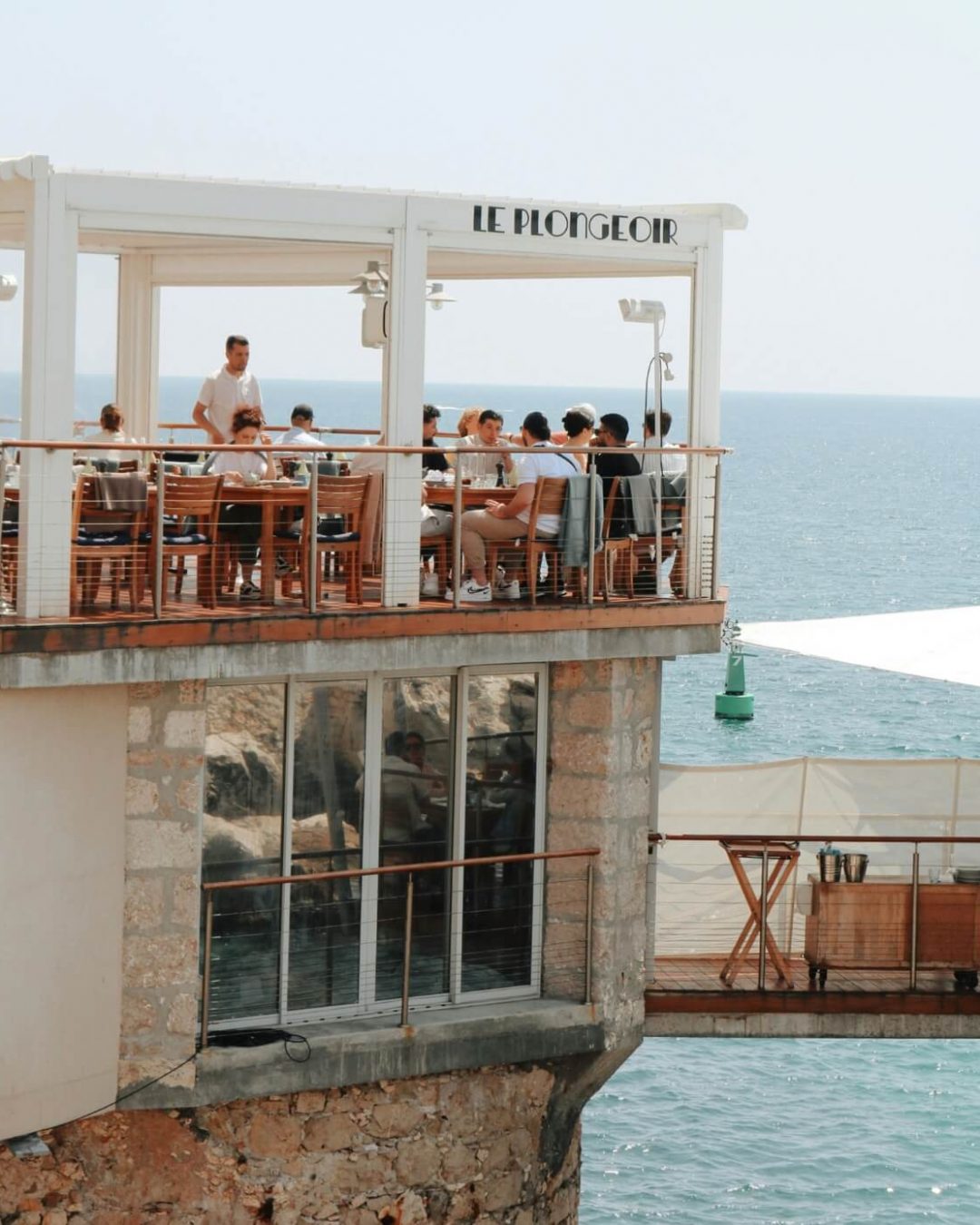 Le Plongeoir, a stone built port restaurant, offers rooftop dining in Nice and is perched above the glittering, topaz Mediterranean Sea.
